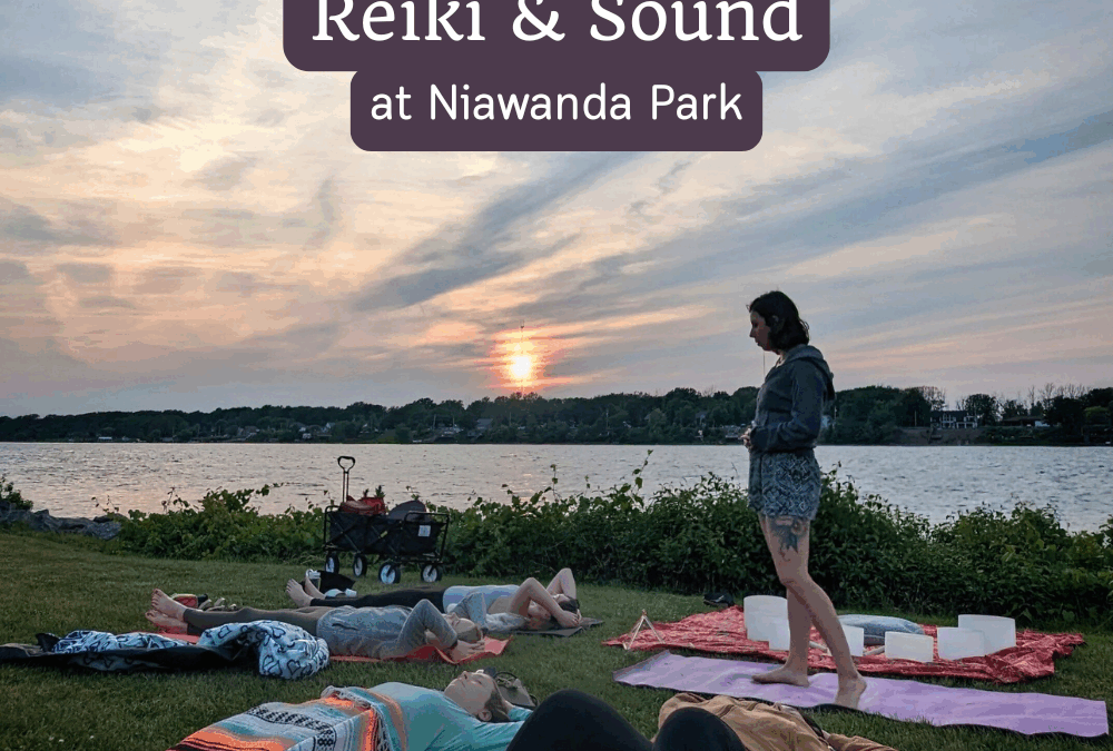 outdoor Reiki and sound bath event in the grass by the water