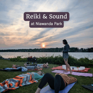 outdoor Reiki and sound bath event in the grass by the water